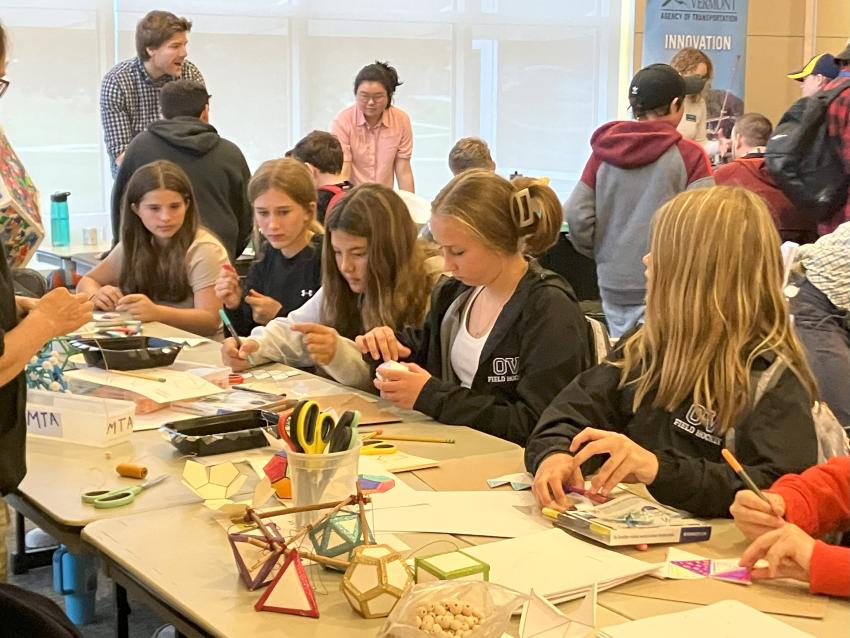Middle school students engaged with hands-on exhibits at STEM fairs in Vermont