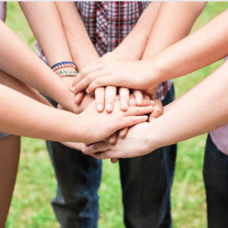 group of teens hand coming together