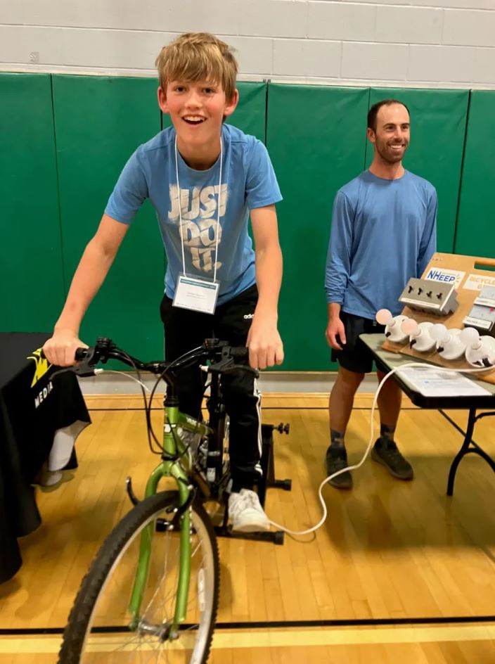 young boy on Bike Generator during Vermont STEM Fair