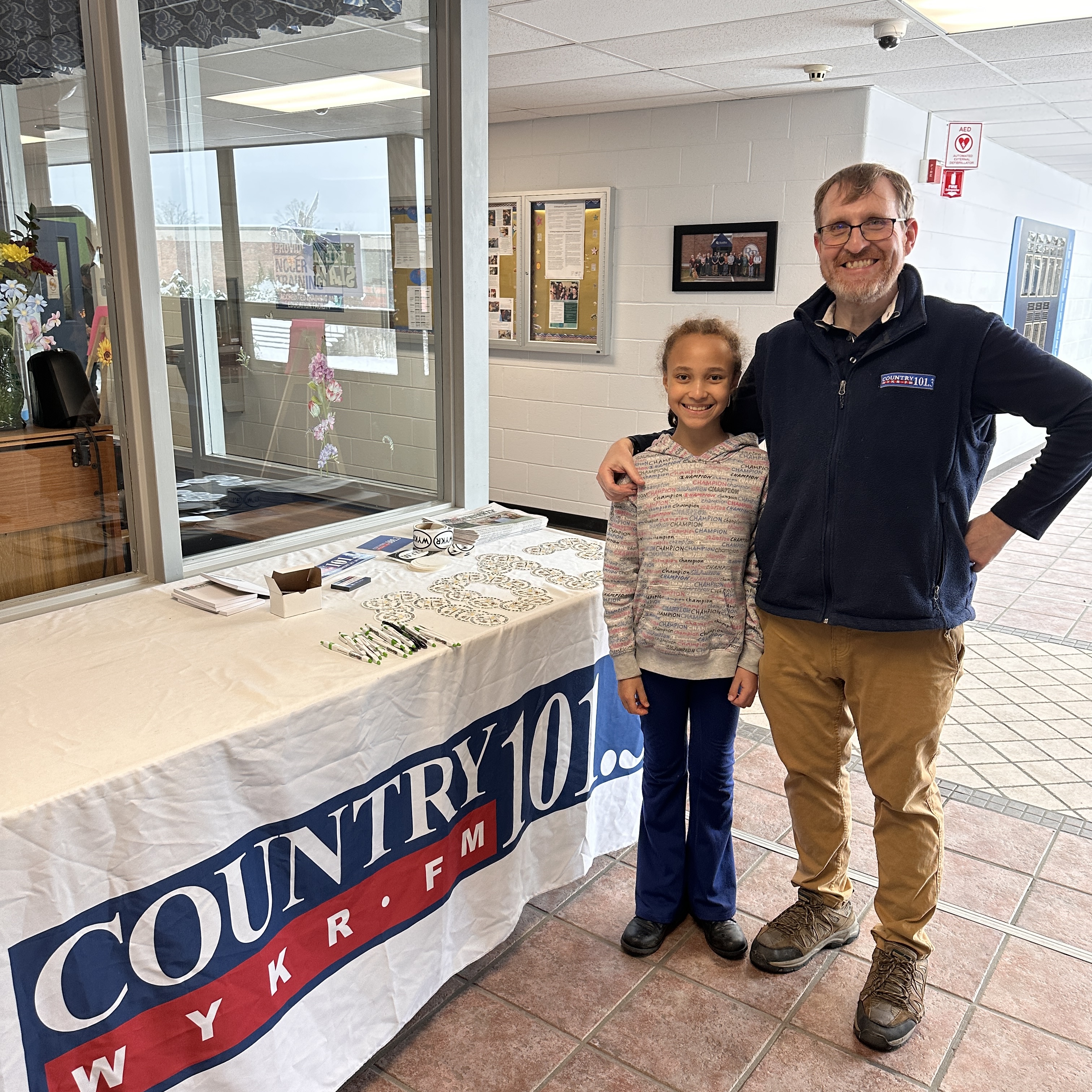 Joshua Smith with his oldest daughter, Elizabeth helping set up for a remote broadcast