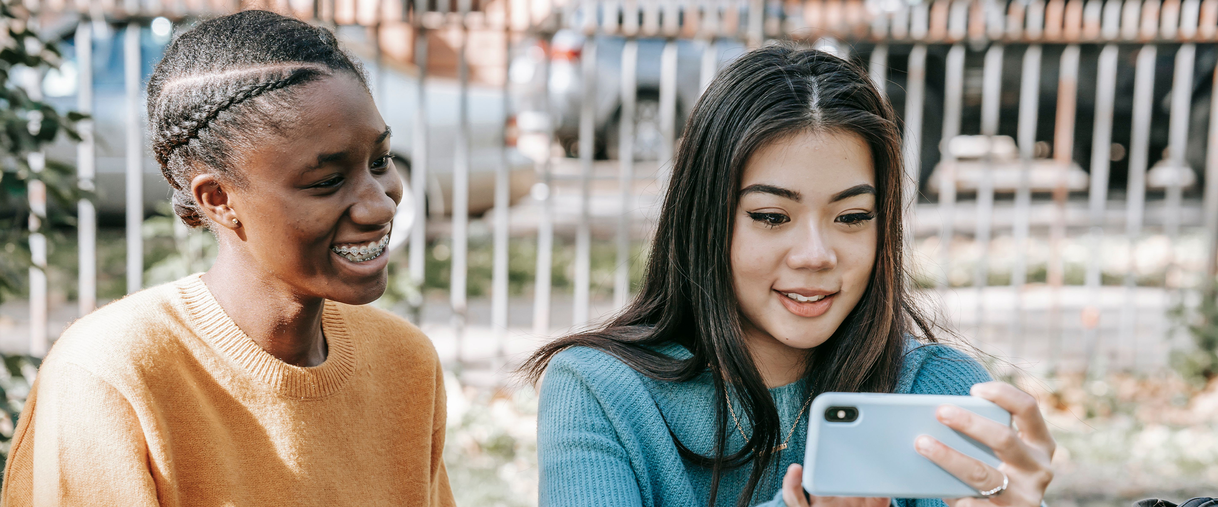 two girls looking at a tablet