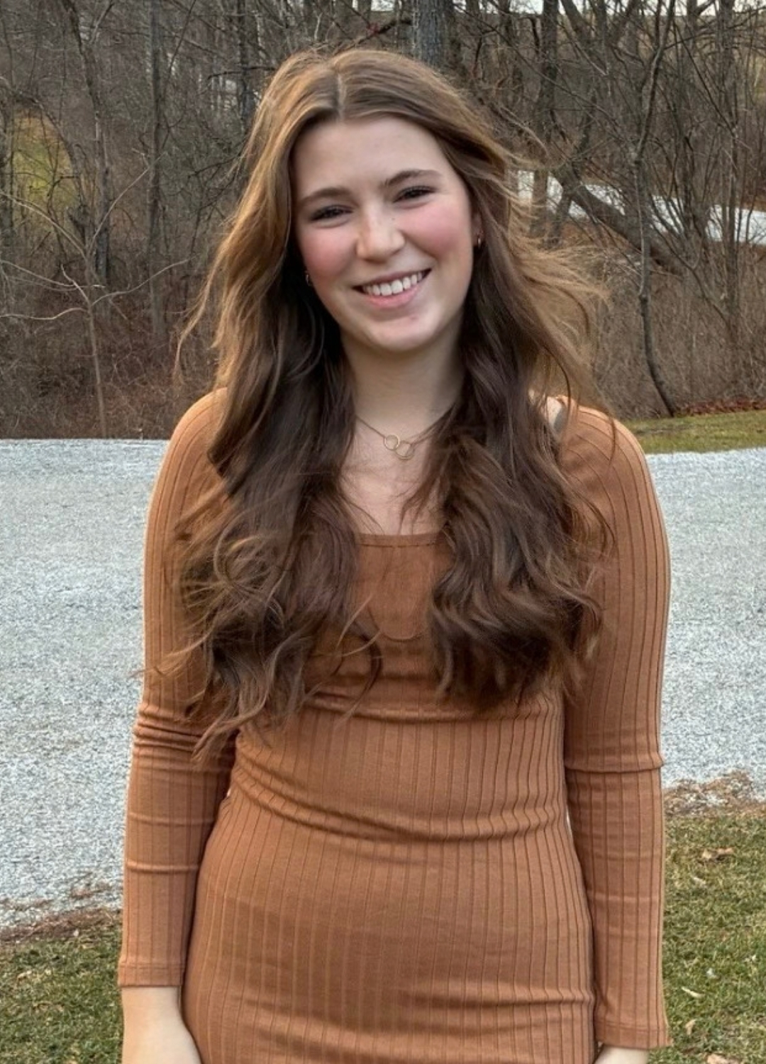 young woman standing front of a road
