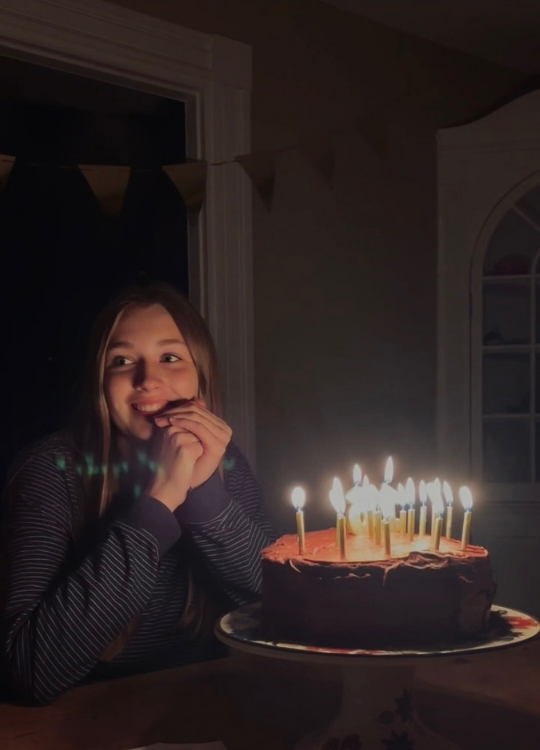 photo of young woman and birthday cake