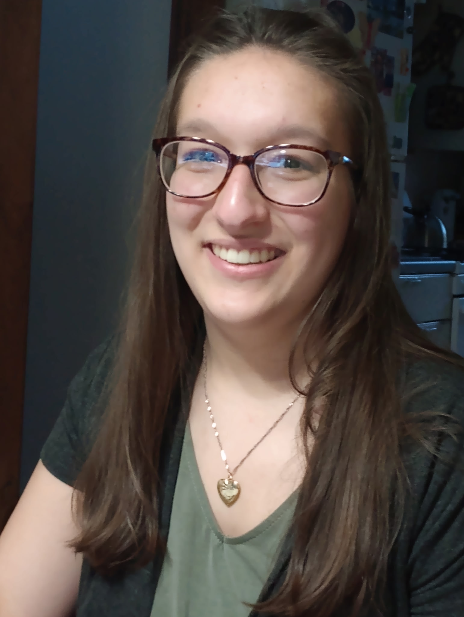 young woman with glasses smiling