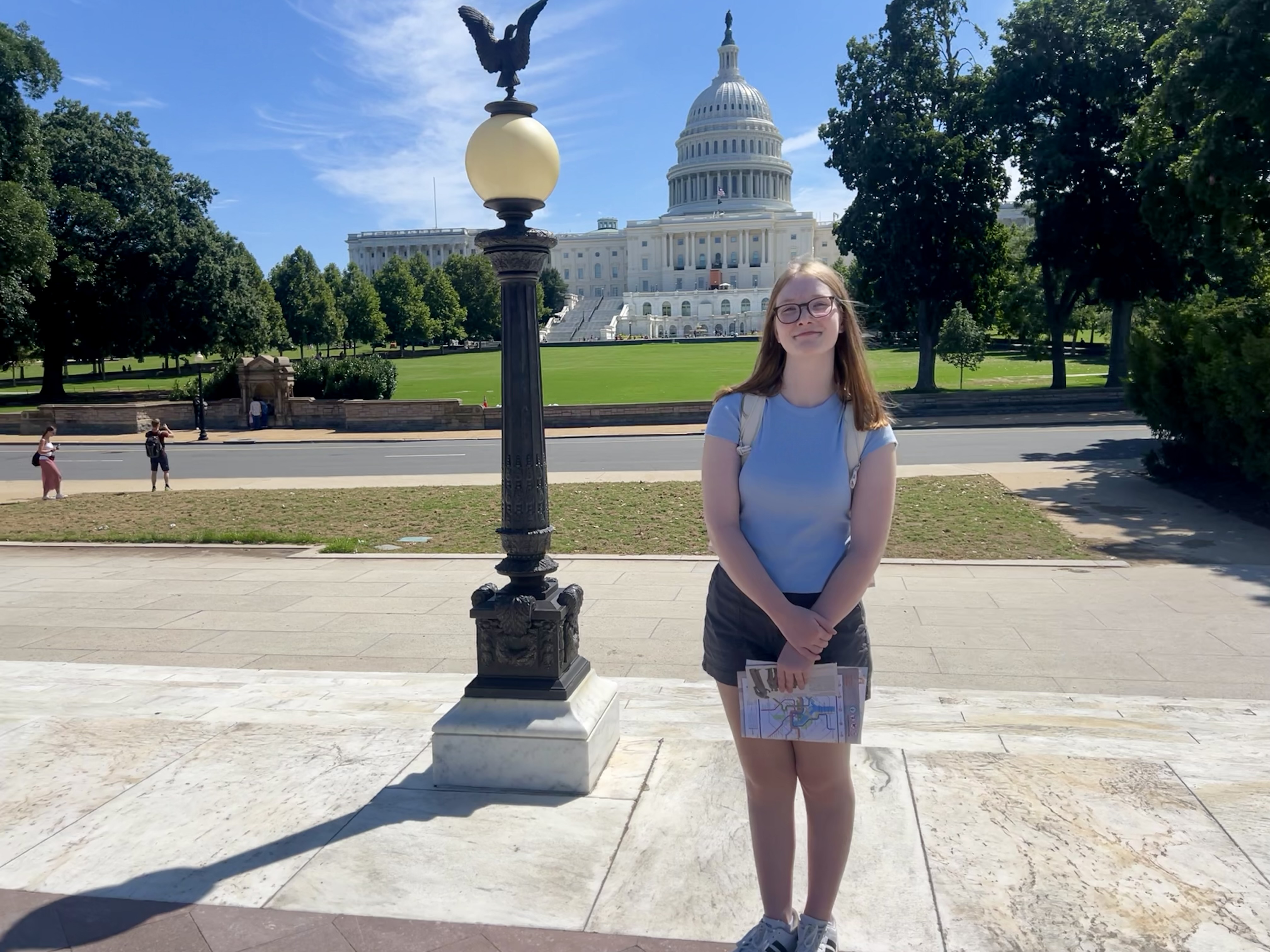 young woman standing in fornt of Vermont Capital building
