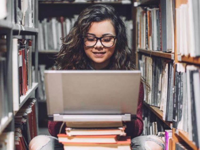 girl in library stacks