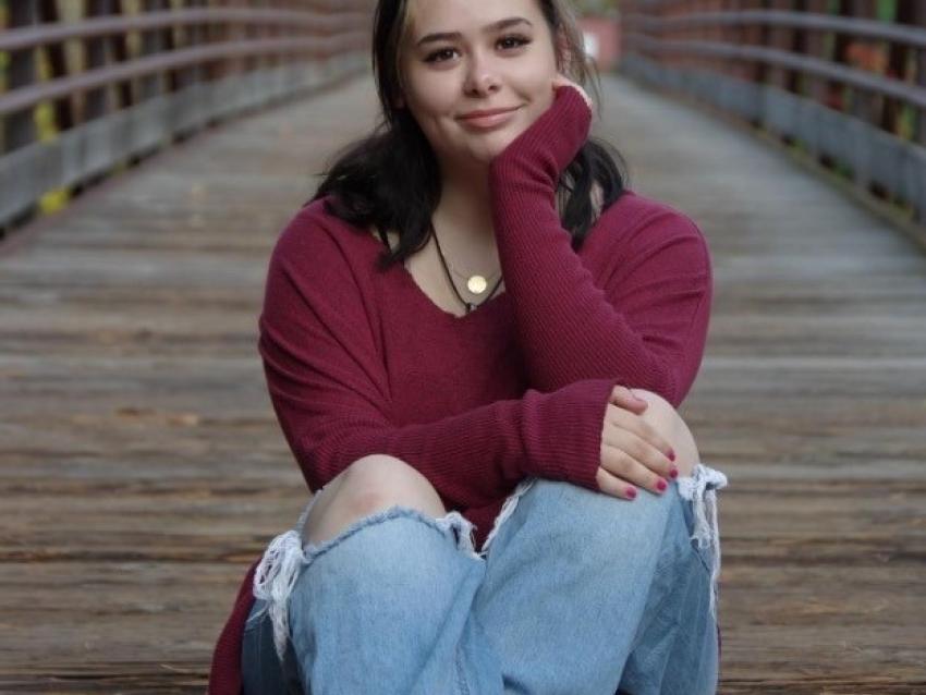 Sapphire Jackson sitting on bike path bridge
