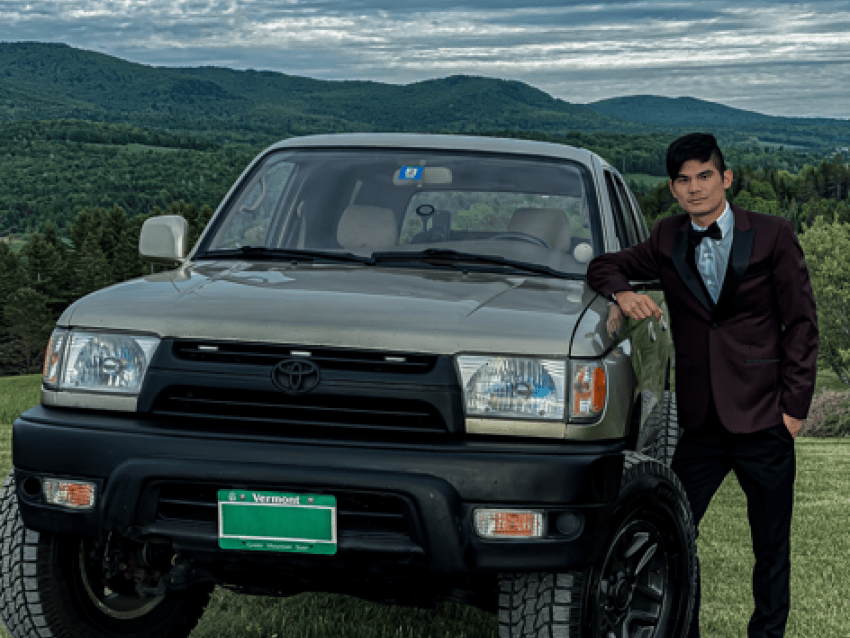 student standing by car