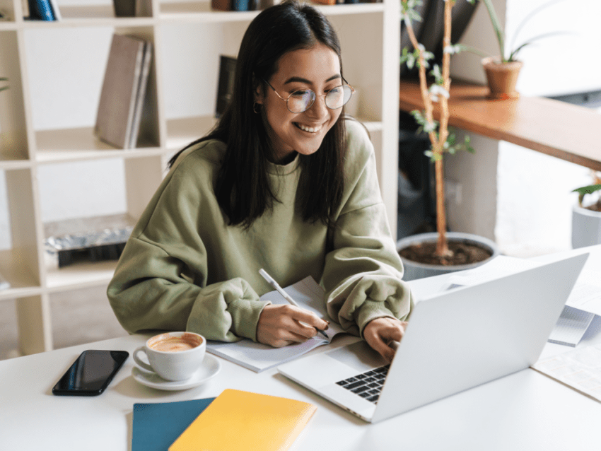 Student reading good news on laptop