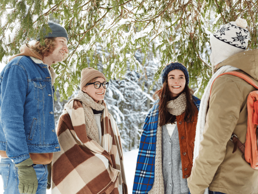 Adult students talking in snow outside