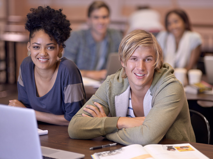 portrait of two students researching their assignments
